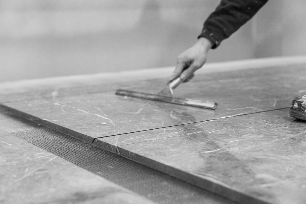 Builder working with natural stone plans