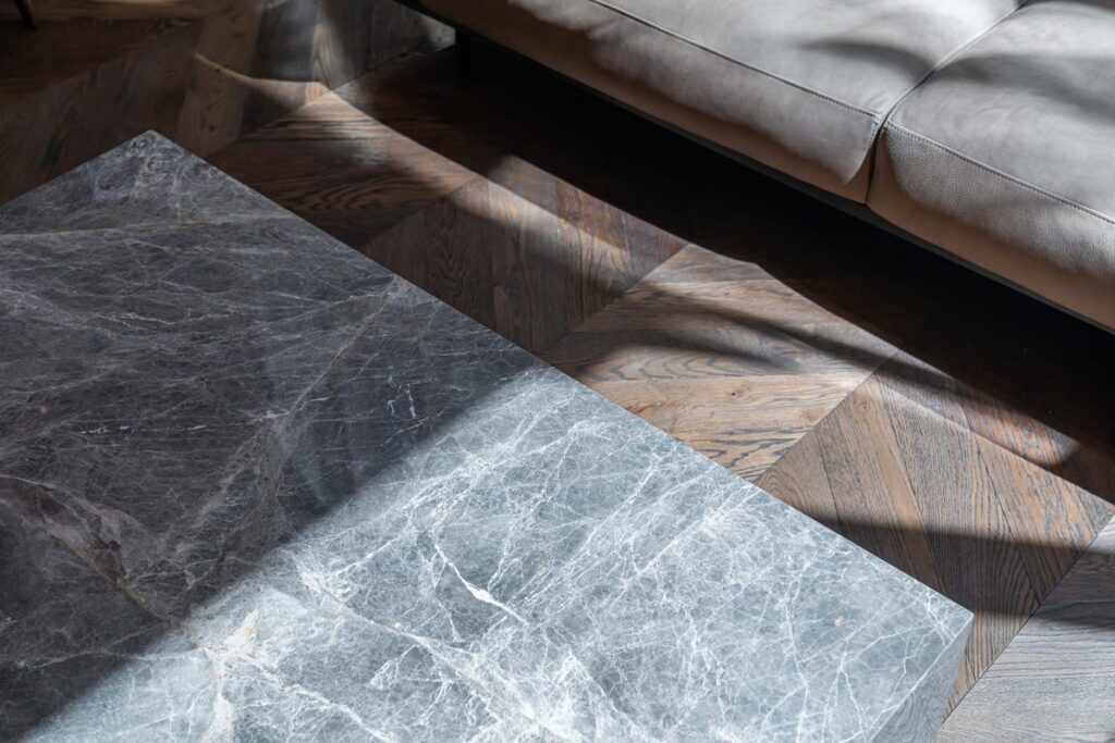 Grey stone surface beside timber flooring and a lounge